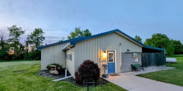 The Phil-Mar Pet Estate building with its blue front door at dusk